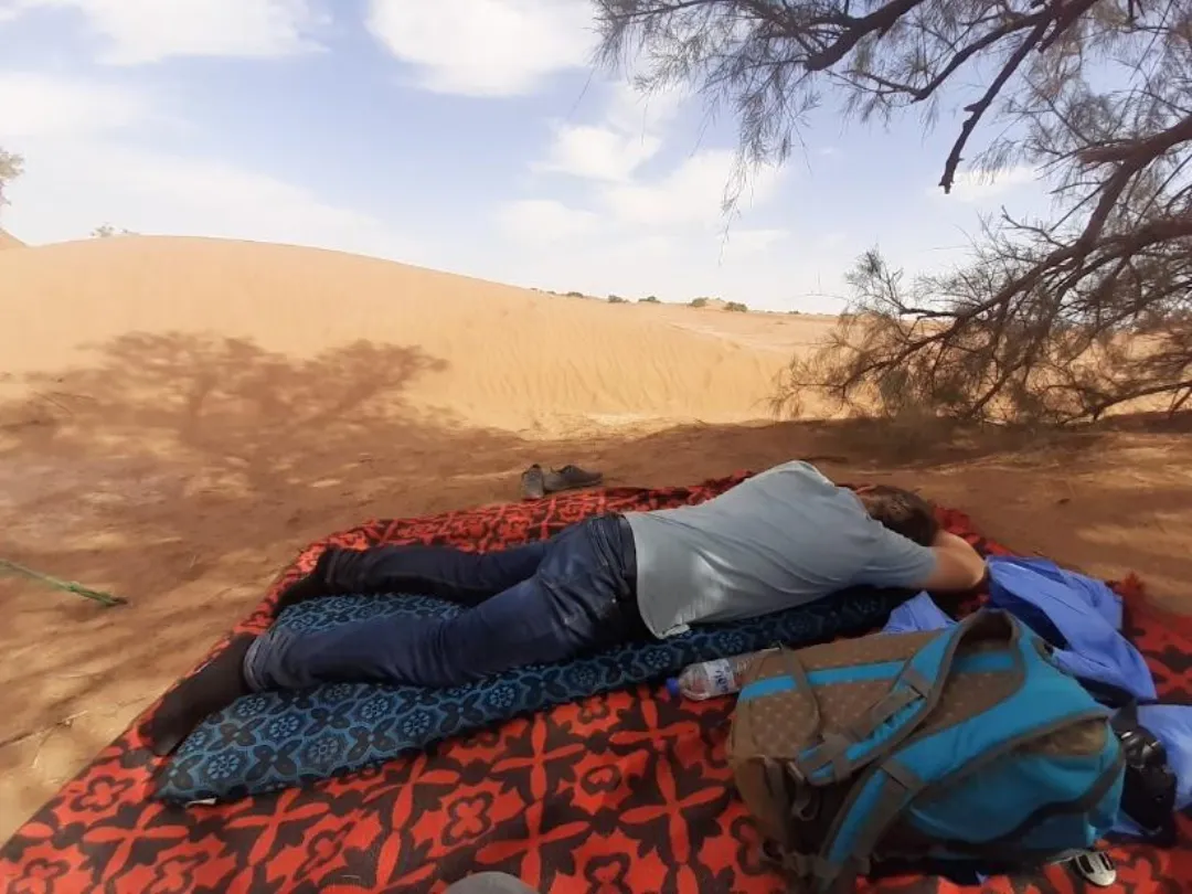 Chiara's husband, tired from the desert heat.