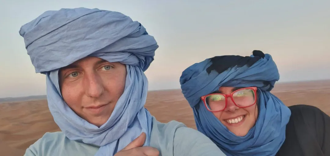 Panoramic view of endless orange sand dunes at sunset in the Sahara.